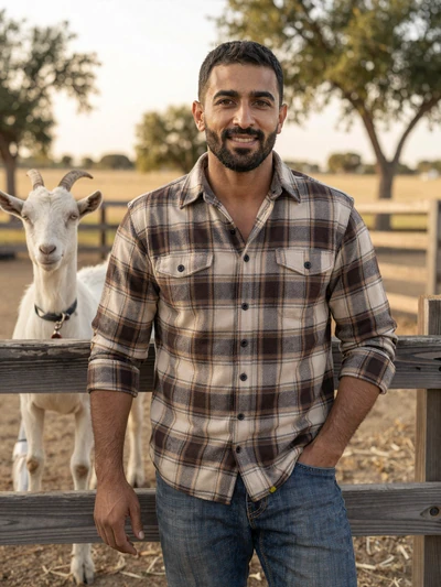 Ibrahim, a 40-year-old Muslim-American goat rancher smiling confidently on his Texas farm